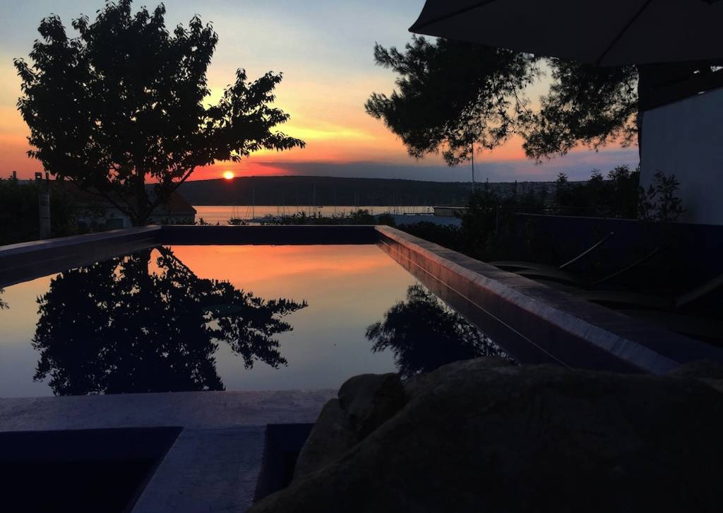 Swimming pool sea view sunset